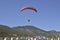 People engage in active sports, paragliding, paraglider hovering on blue sky background