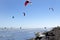 People engaged in kitesurfing on a summer day in a sea