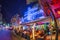 people enjoy the evening in the Columbus restaurant next to famous art deco hotel colony at ocean drive, Miami