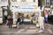 People enjoy fresh herring at stall in centre of amsterdam