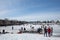 People enjoy outdoor activities, playing pond hockey, sledding ice skating on the snow.