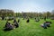 People enjoy picnic and sunny spring weather in Green park, London
