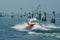 People enjoy ride by a speed boat at Grand Canal in Venice, Italy.