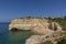 People enjoy the scenic beach at the Algarve coast near Carvoeiro and follow the rules for tourists at the beach according Corona