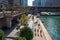 People enjoy summer in Chicago on riverwalk, splash pad, boat, Wacker Dr., and el trail over Chicago River