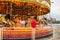 People enjoy themselves on a carousel at the Liverpool Docks, Port of Liverpool, late on a cloudy afternoon