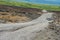 People enjoy the view from the asphalt road over volcanic lava of Piton de la fournaise volcano in Sainte-Rose De La Reunion, Fran