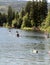 People are enjoying kayaking and swimming in Heffley Lake near Sun Peaks Resort, BC, Canada.