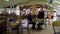 People enjoying meal in mall food court cafeteria.