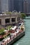 People enjoying the river walk on the Chicago River in summer