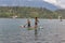 People enjoying standup paddle boarding in the Bled lake, Slovenia