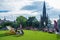 People enjoying the sun on lounge chairs near Scott Monument on