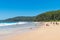 People enjoying the sunny weather at Pebbly Beach, a popular camping area with great surfing beach and bush walks within