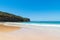 People enjoying the sunny weather at Pebbly Beach, a popular camping area with great surfing beach and bush walks within