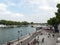 People are enjoying their free time on the banks of river Seine, in Paris
