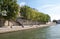 People are enjoying their free time on the banks of river Seine, in Paris