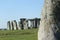 People enjoying view of Stonehenge, Neolithic ancient standing stone circle monument, UNESCO World Heritage Site