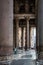 People at the entrance of Pantheon building with tall columns in the foreground.