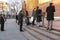 People at the Eternal flame in the Alexander garden near the Kremlin wall. The young man knelt down as a sign of respect and memor