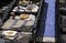 People examining the goods on display at the famous Feira da Ladra (Flea Market) in Lisbon, Portugal.