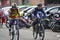 People exercising bicycles in city park on saturday.