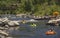 People families having fun cooling off floating in inflatable tubes down the San Juan River on hot summer day in Pagosa Springs