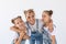 People, family and children concept - portrait of a lovely mother embracing her twin daughters on white background