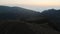 People on famous Bakhmaro sunset viewpoint watch sunset over clouds in Georgia