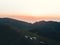 People on famous Bakhmaro sunset viewpoint watch sunset over clouds in Georgia