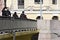 People feed pigeons from the bridge in summer day