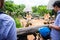 People feeding food to giraffes in Dusit Zoo