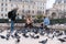 People feeding the pigeons in front of Notre-Dame Square, Paris, France