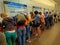 People fill in embarkation form on desk at the airport