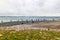 People fishing on danish shore of Oresund, outside the Kronborg castle. View of Swedish coast and Scandlines ferry boat