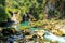 People fishing in Semuc champey natural pool, waterfall and rocks from riverside