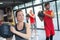 People in fitness class holding round prop