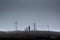 People in the fog near the huge cross and monument during raining day