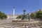 People, fountain and statue at the Rossio Square in Lisbon