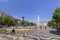 People, fountain and statue at the Rossio Square in Lisbon