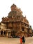 People in front of the ornamental tower in the ancient Brihadisvara Temple in Thanjavur, india.