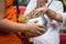 People give alms to a Buddhist monk at temple