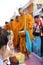 People give food offerings to monks