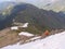 People go down from the top of the mountain on a snowy ridge