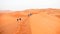 People going through the sand dunes in the Sahara Desert, Morocco