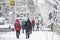 People going up to overpass bridge to moving other side of street in snowy day