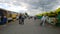 People at good real local farmer outdoor market. Customers buy healthy, fresh food, grown locally. Cloudy sky. Trade show. Leadin
