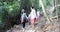 People Group With Backpacks Trekking On Forest Path Walk Downhill, Young Men And Woman On Hike