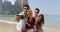 People Group On Beach Taking Selfie Photo On cell Smart Phone Embracing Happy Cheerful Men And Women Tourists On