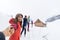 People Group Near Wooden Country House Winter Snow Resort Cottage