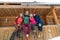 People Group Sitting On Terrace Wooden Country House Winter Snow Resort Cottage